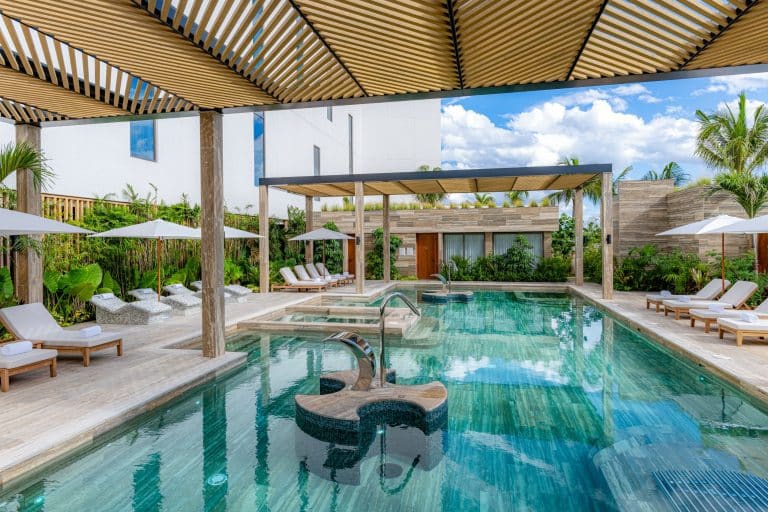 Luxury resort pool with guest amenities and scenic view