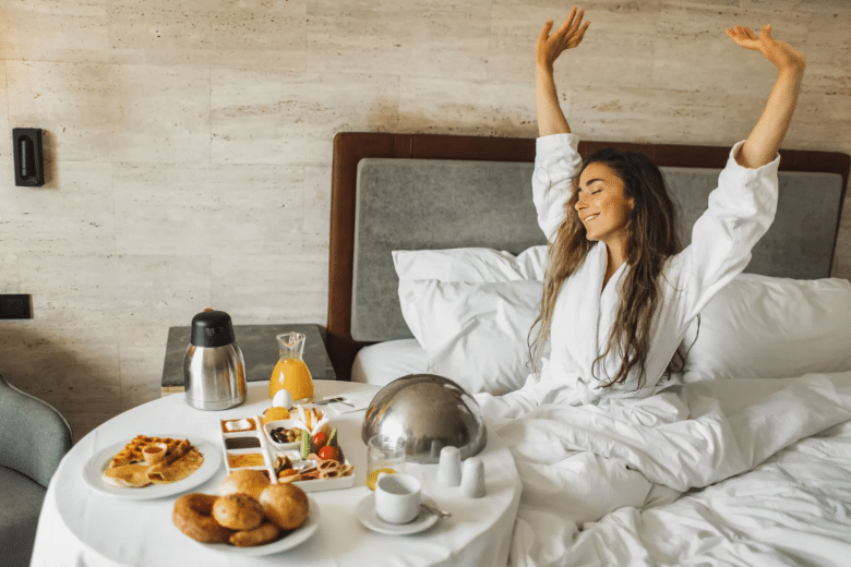 Happy hotel guest in bed