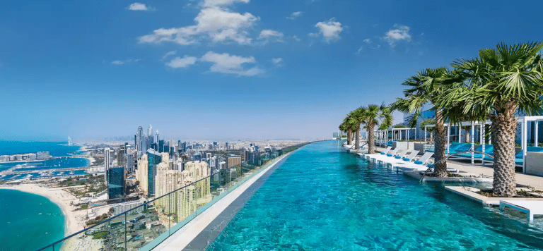 Luxury resort infinity pool overlooking a modern coastal skyline – ideal imagery for hotel email marketing and 2026 luxury travel trends