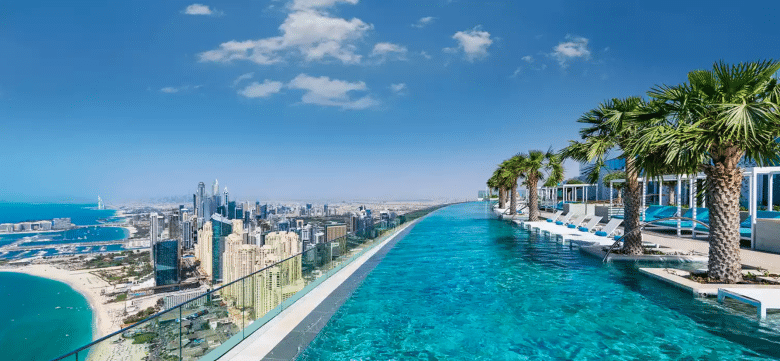 Luxury resort infinity pool overlooking a modern coastal skyline – ideal imagery for hotel email marketing and 2026 luxury travel trends