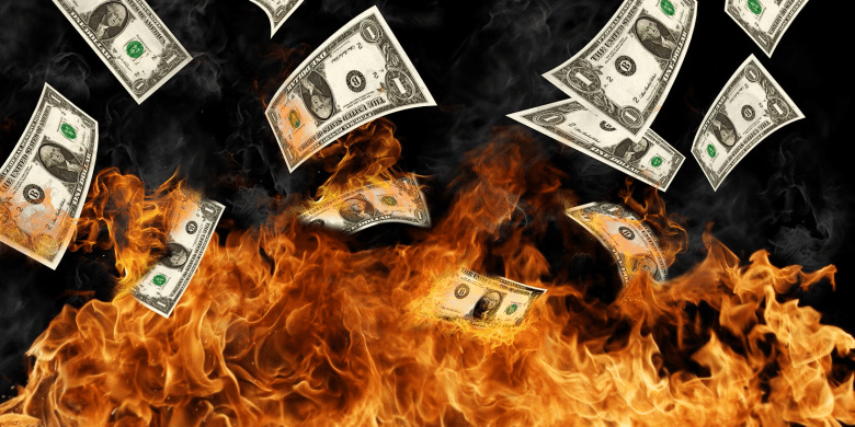 U.S. dollar bills burning in flames, symbolizing revenue lost to OTA commissions and margin erosion in luxury hotel distribution.